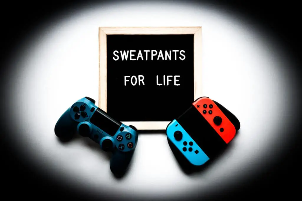A ps4 controller and a Nintendo wii controller lain next to a sign that reads "Sweatpants for life", two recreational actives disputed on in regards to them being an actual routine conducive to learning or not.