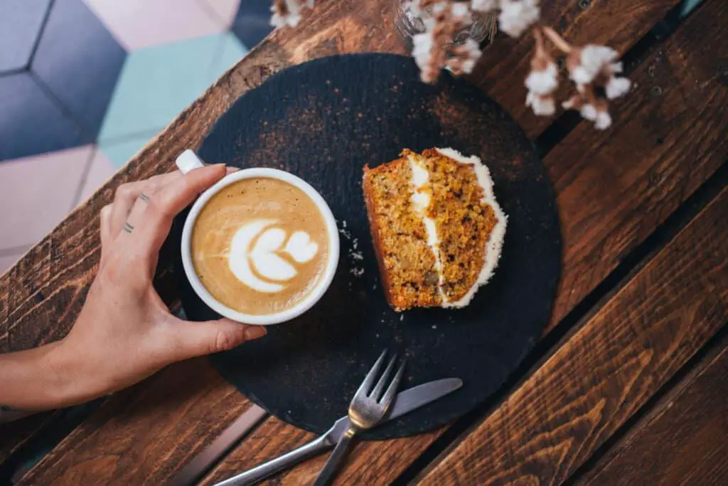 A cup of cappuccino and moderate serving of cake. An attempt to make routines more enjoyable.