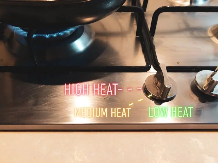 A stove showing heat control as well as a pan where the fried egg is cooking.