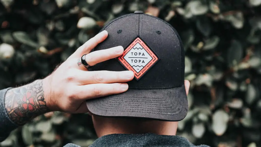 Man wearing a backwards hat/cap.