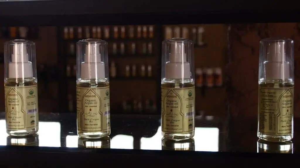 Bottles of Argan conditioner hair oils sitting on a table.