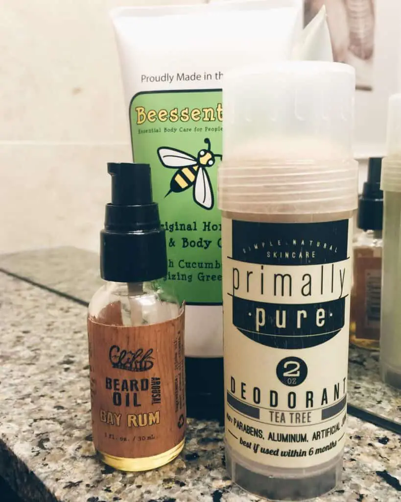 A bottle of beard oil and a bottle of tea tree deodorant.