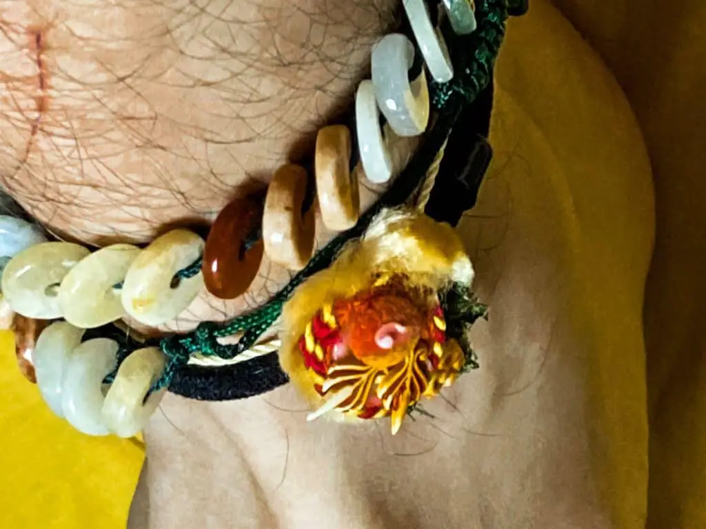 Close up of man wearing multiple anklets.