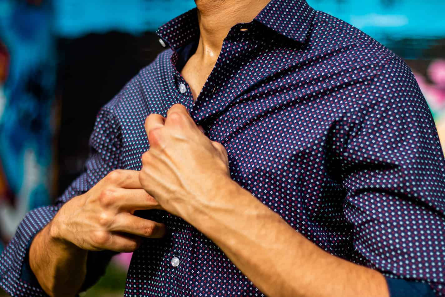 Man sweating whilst wearing shirt.