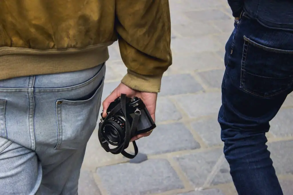 Close up of man holding camera.