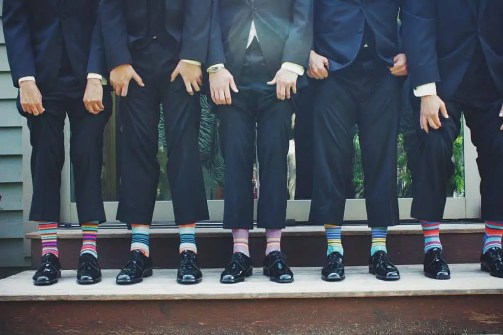 Group of men standing together wearing suits. 