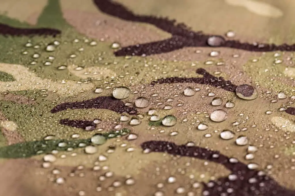 Water droplets resting atop fabric.